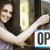 Young Woman Hanging "Open" Sign Outside Store